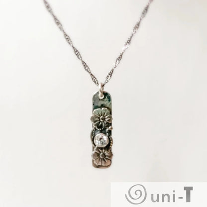 Flower Tag Necklace with cubic zirconia on sterling silver chain, featuring floral accents and antiqued rope chain for elegant sparkle.