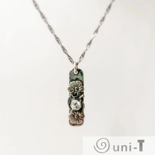 Flower Tag Necklace with cubic zirconia on sterling silver chain, featuring floral accents and antiqued rope chain for elegant sparkle.