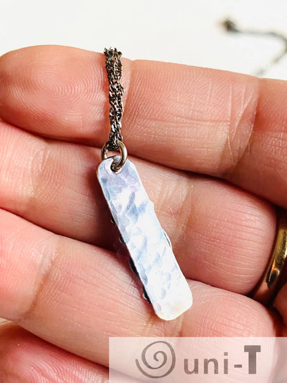 Back view of hammered silver Flower Tag Necklace pendant, showing textured finish and quality sterling silver craftsmanship.