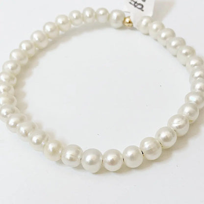 Elegant stretch cord freshwater pearl bracelet featuring uniformly sized large-hole pearls, perfect for versatile styling.