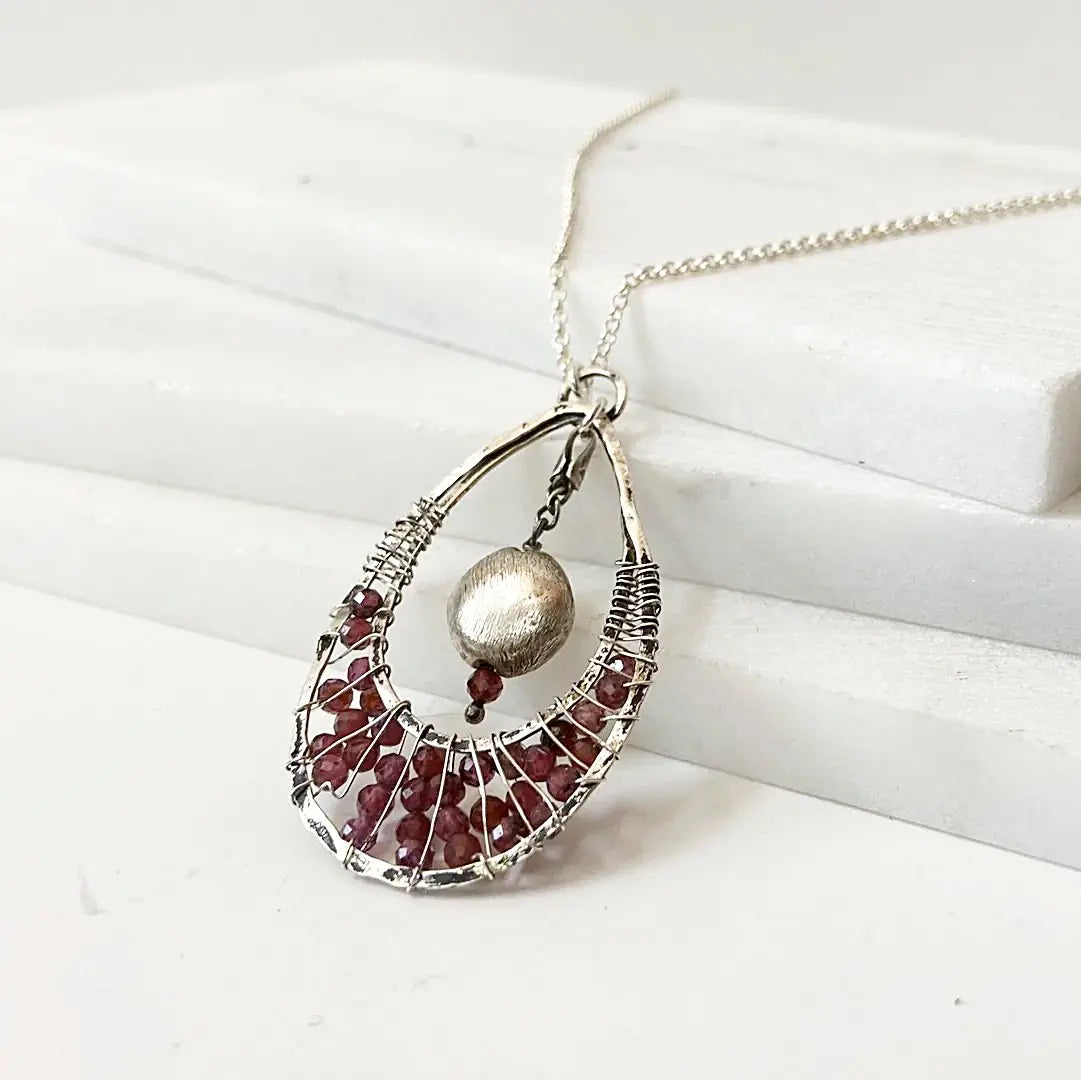 Side view of Garnet Necklace - Teardrop Pendant | 18" Sterling Silver highlighting the handcrafted wire design and gemstone arrangement.