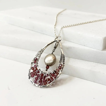 Side view of Garnet Necklace - Teardrop Pendant | 18" Sterling Silver highlighting the handcrafted wire design and gemstone arrangement.