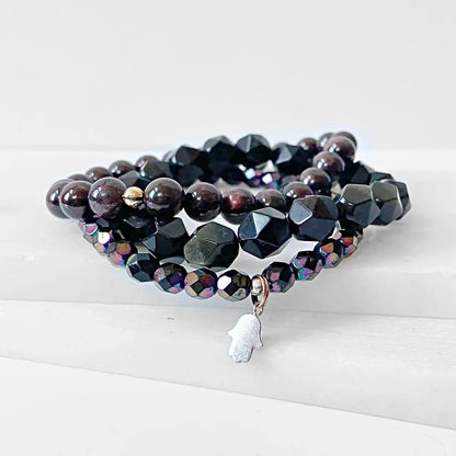 Garnet Black Obsidian Bracelet stack with triple stretch design, featuring faceted black obsidian, garnet, and Czech glass beads.