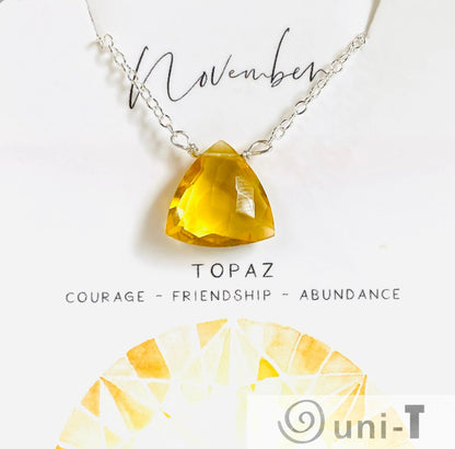 Topaz gemstone necklace for November with sterling silver chain. Triangle cut stone symbolizes courage, friendship, and abundance.