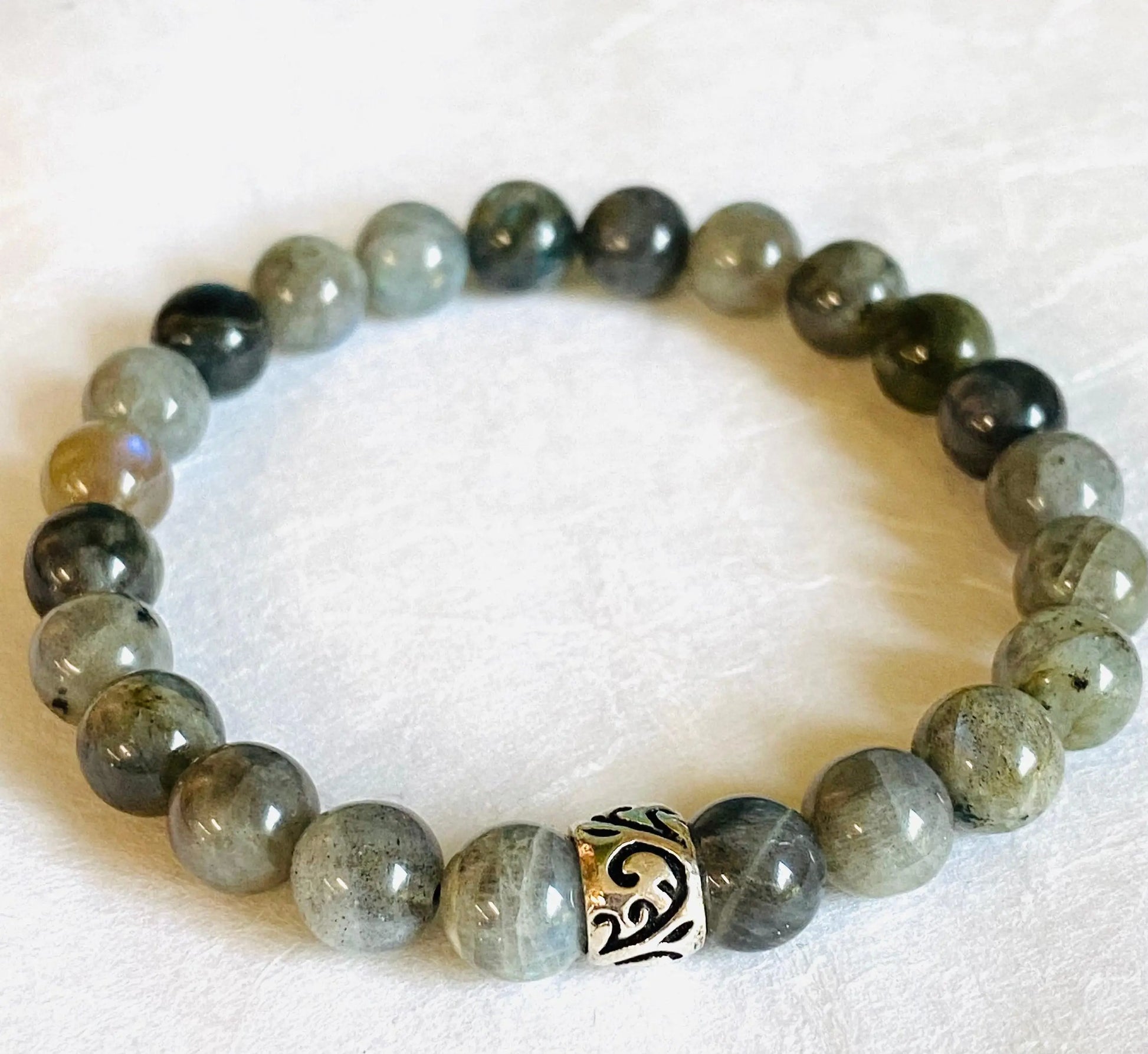 Labradorite gemstone stretch bracelet with sterling silver accent bead, offering a stylish and spiritual accessory.