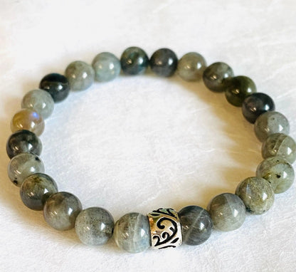 Labradorite gemstone stretch bracelet with sterling silver accent bead, offering a stylish and spiritual accessory.