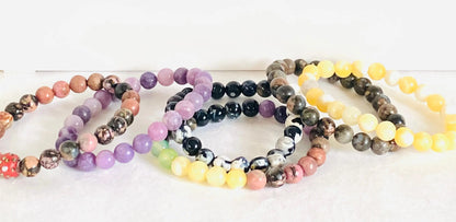 Set of colorful gemstone stretch bracelets including labradorite, agate, calcite, and chalcedony, ideal for stacking and gifting.