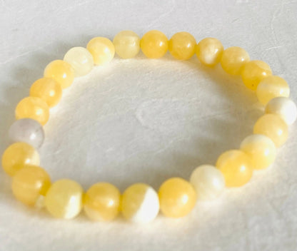 Yellow calcite gemstone stretch bracelet with smooth round beads, perfect for uplifting energy and fashion wear.