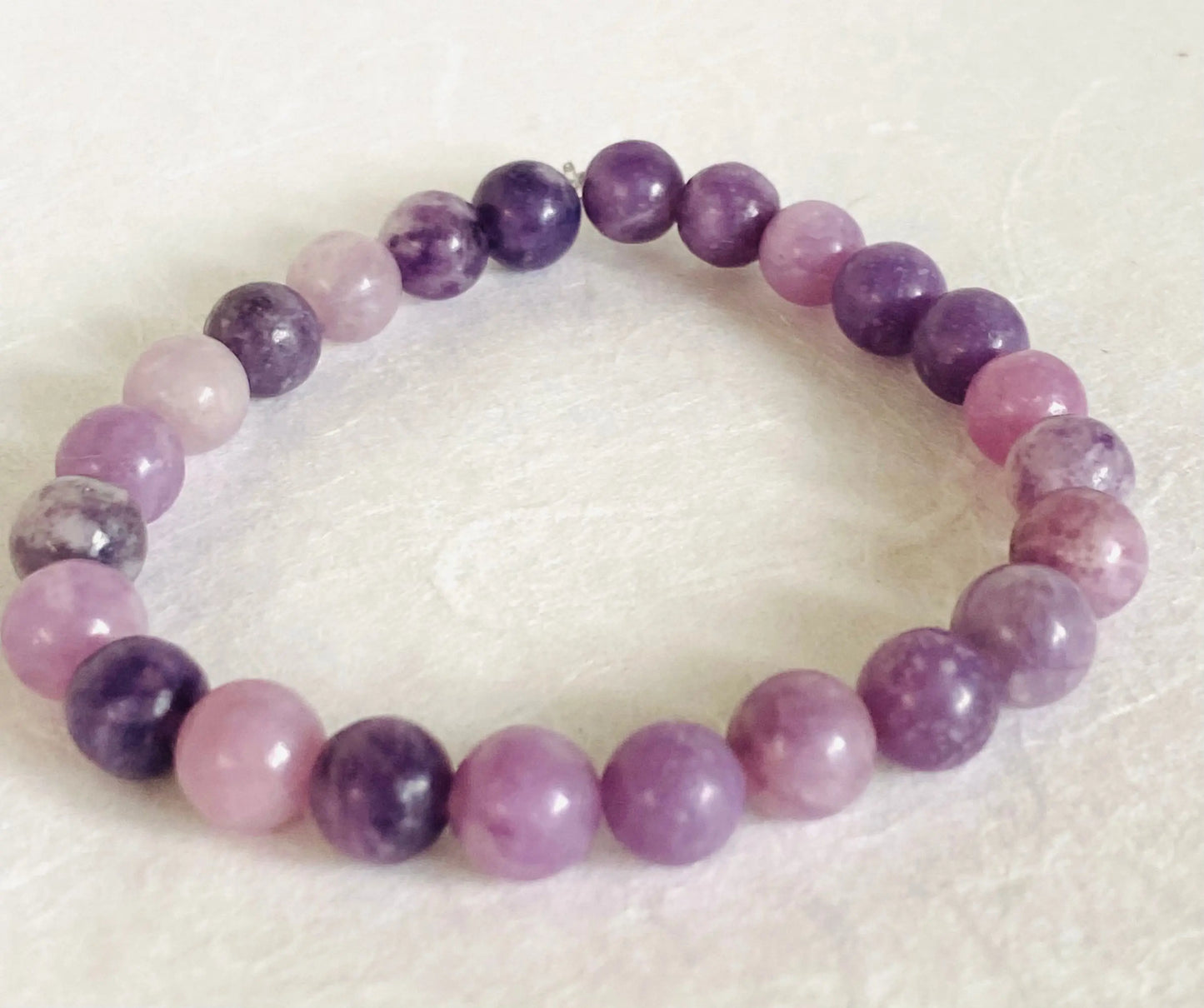 Purple chalcedony gemstone stretch bracelet with polished round beads, ideal for spiritual and fashion use.