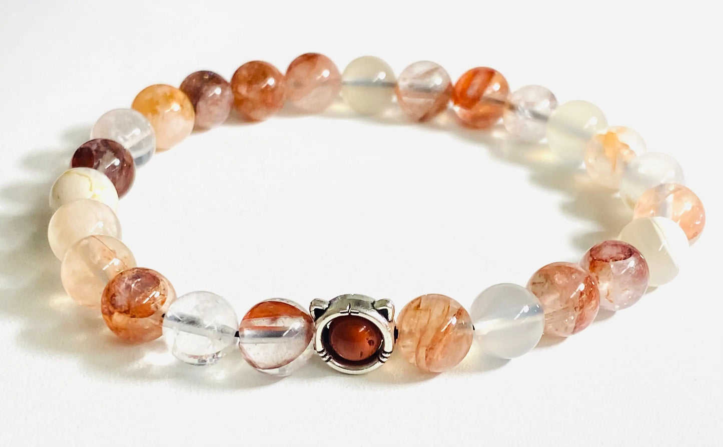 Sunstone and clear quartz gemstone stretch bracelet with sterling silver clasp, offering a radiant and elegant design.