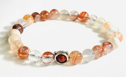 Sunstone and clear quartz gemstone stretch bracelet with sterling silver clasp, offering a radiant and elegant design.
