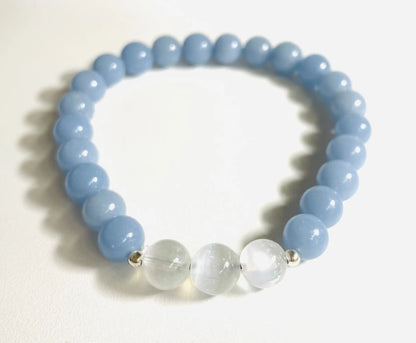 Blue chalcedony and selenite gemstone stretch bracelet with silver accents, perfect for calming energy and fashion.