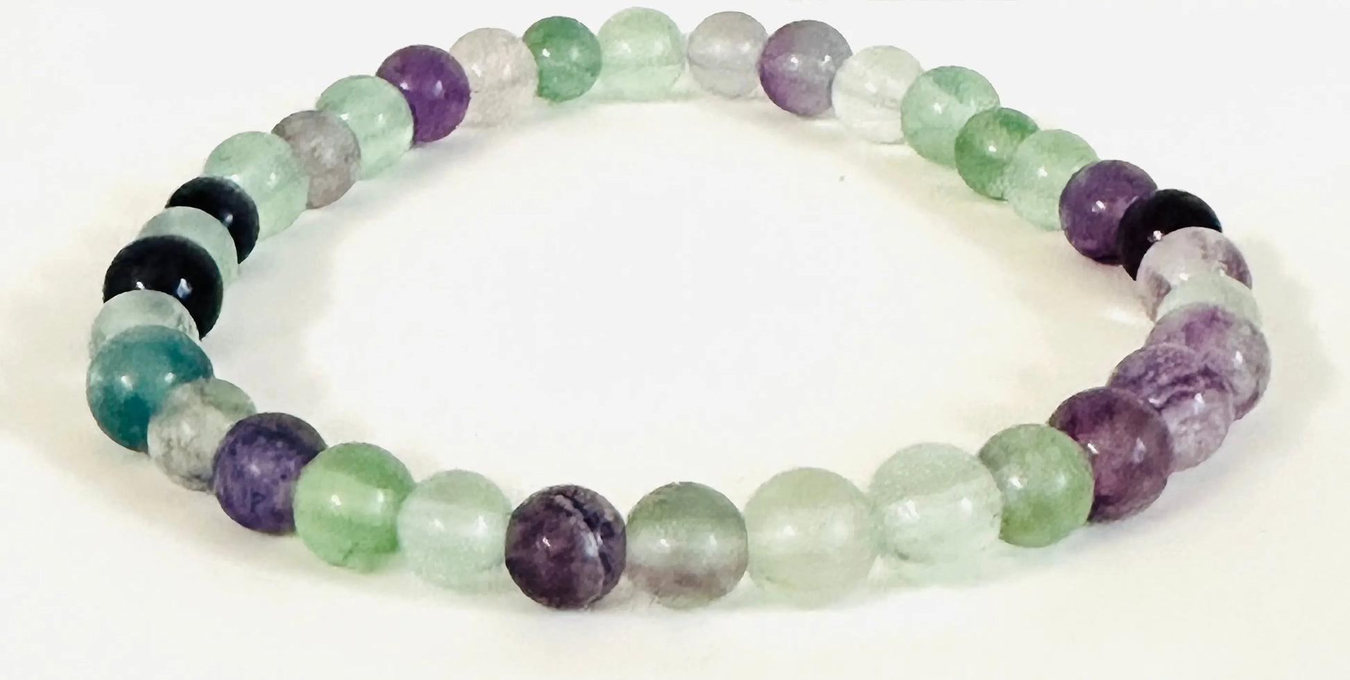 Green and purple fluorite gemstone stretch bracelet with translucent beads, perfect for clarity and energy balance.