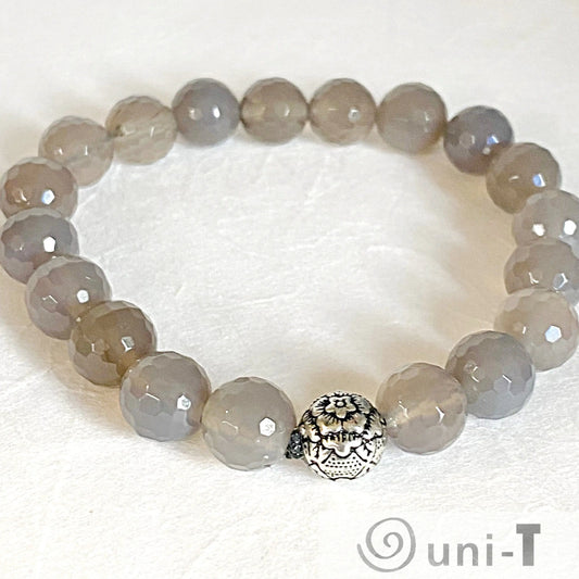 Agate Gemstone Stretch Bracelet with faceted grey beads and silver centerpiece. Stylish accessory that fits most wrists.