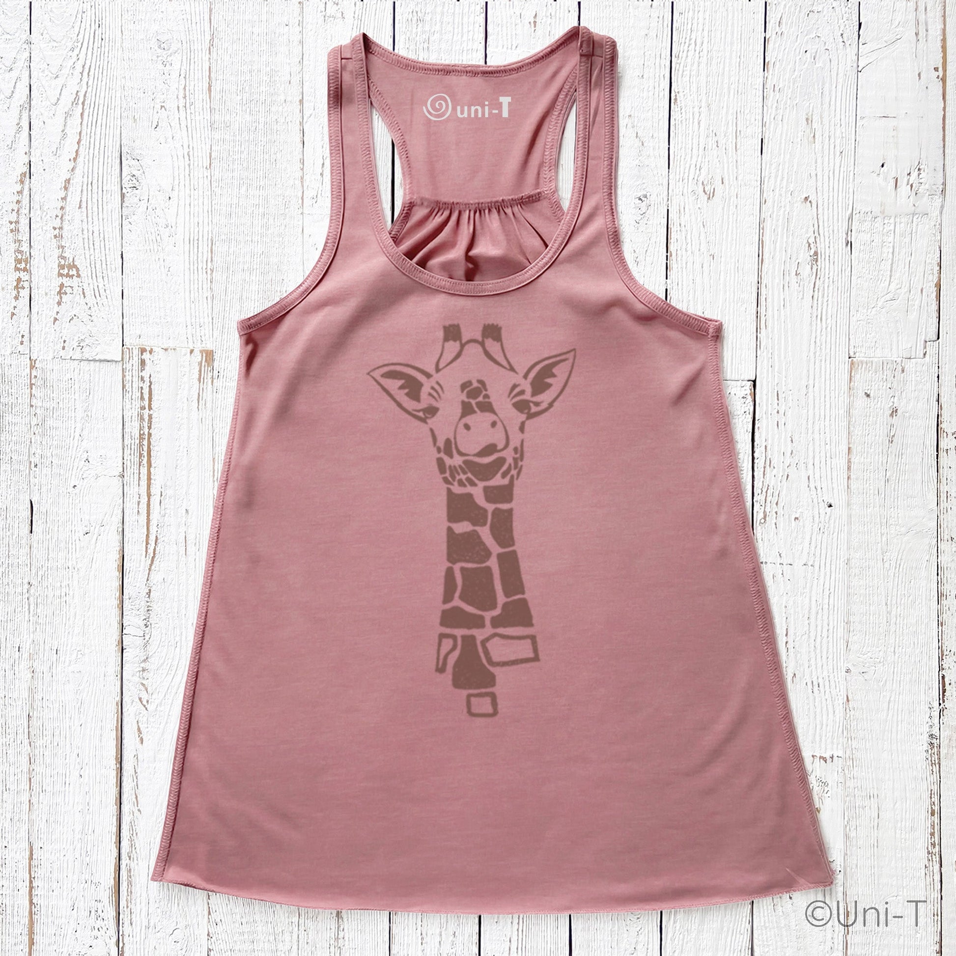 Pink flowy giraffe tank top for women with brown giraffe illustration. Lightweight racerback top ideal for gifting and summer outfits.