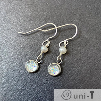 Close-up of Glitter and Pearl Earrings - Pearl Earrings | Sterling Silver, Freshwater Pearls with iridescent glitter discs and freshwater pearls on black background.