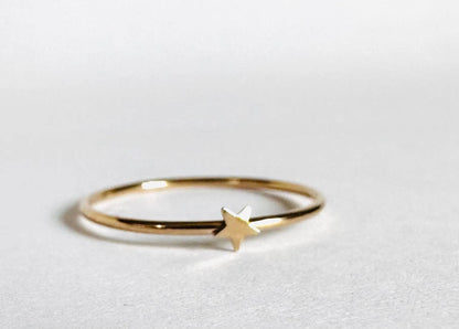 Dainty gold filled ring with a small star charm, perfect for stacking or wearing as a subtle statement piece.
