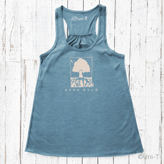"Grow More" flowy tank top in blue with tree and roots graphic, sustainable fashion for women in gardening and personal growth apparel.