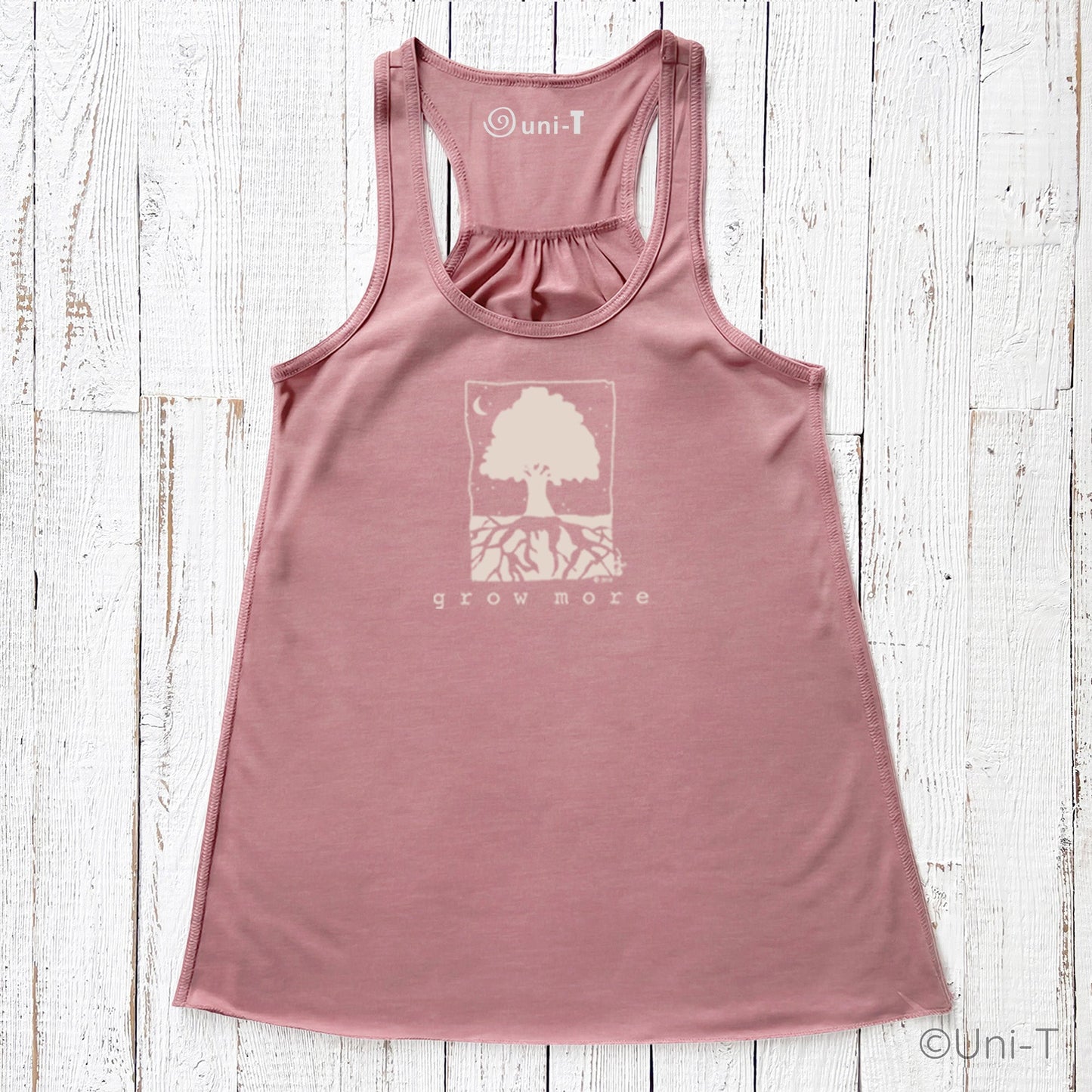 "Grow More" flowy tank top in mauve pink with nature-inspired print, perfect for eco-conscious women embracing personal growth.