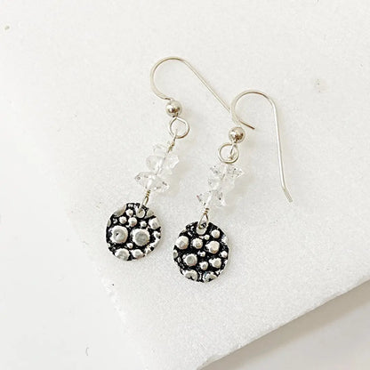 Herkimer Diamond Silver Earrings with textured sterling silver circle charms and wire-wrapped clear Herkimer beads. Elegant handmade jewelry.