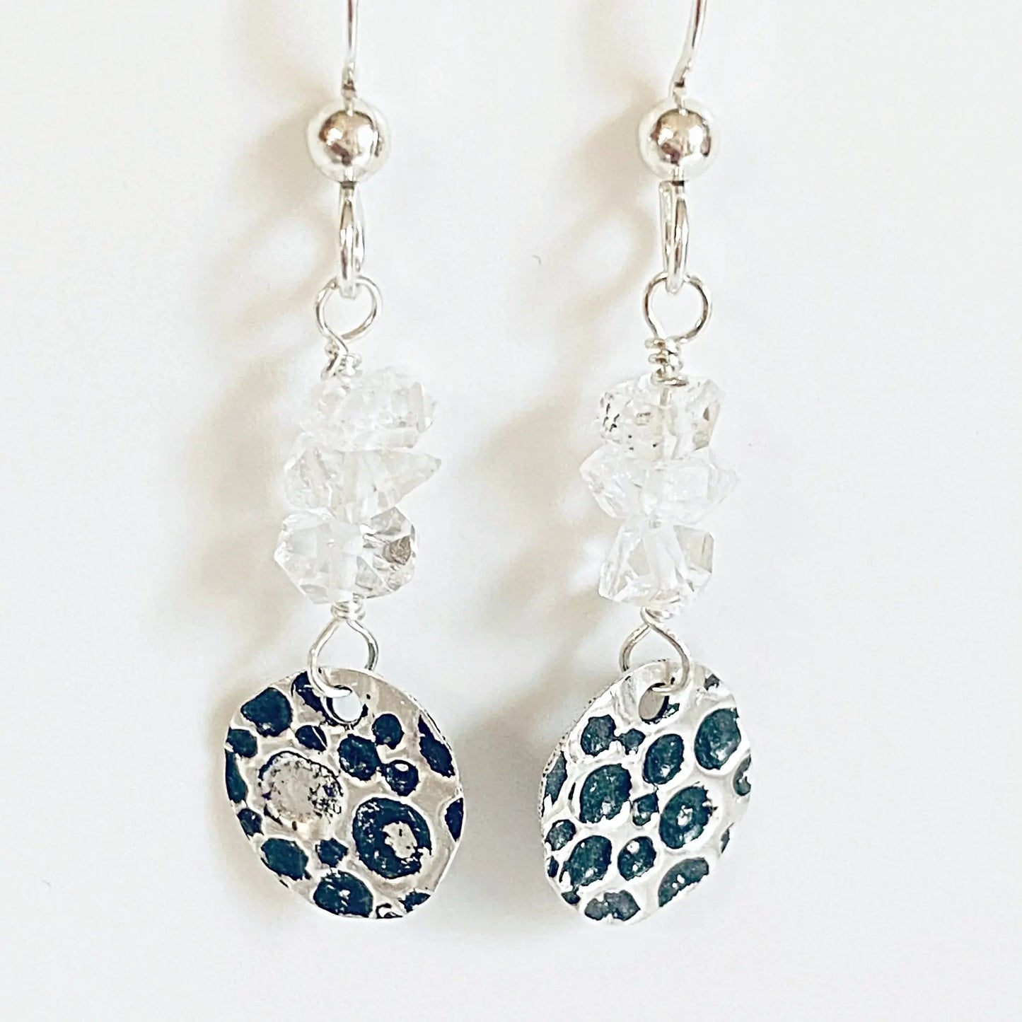 Herkimer Diamond Silver Earrings with dark-accented sterling circle charms and raw crystal beads. Unique artisan earrings for elegant style.