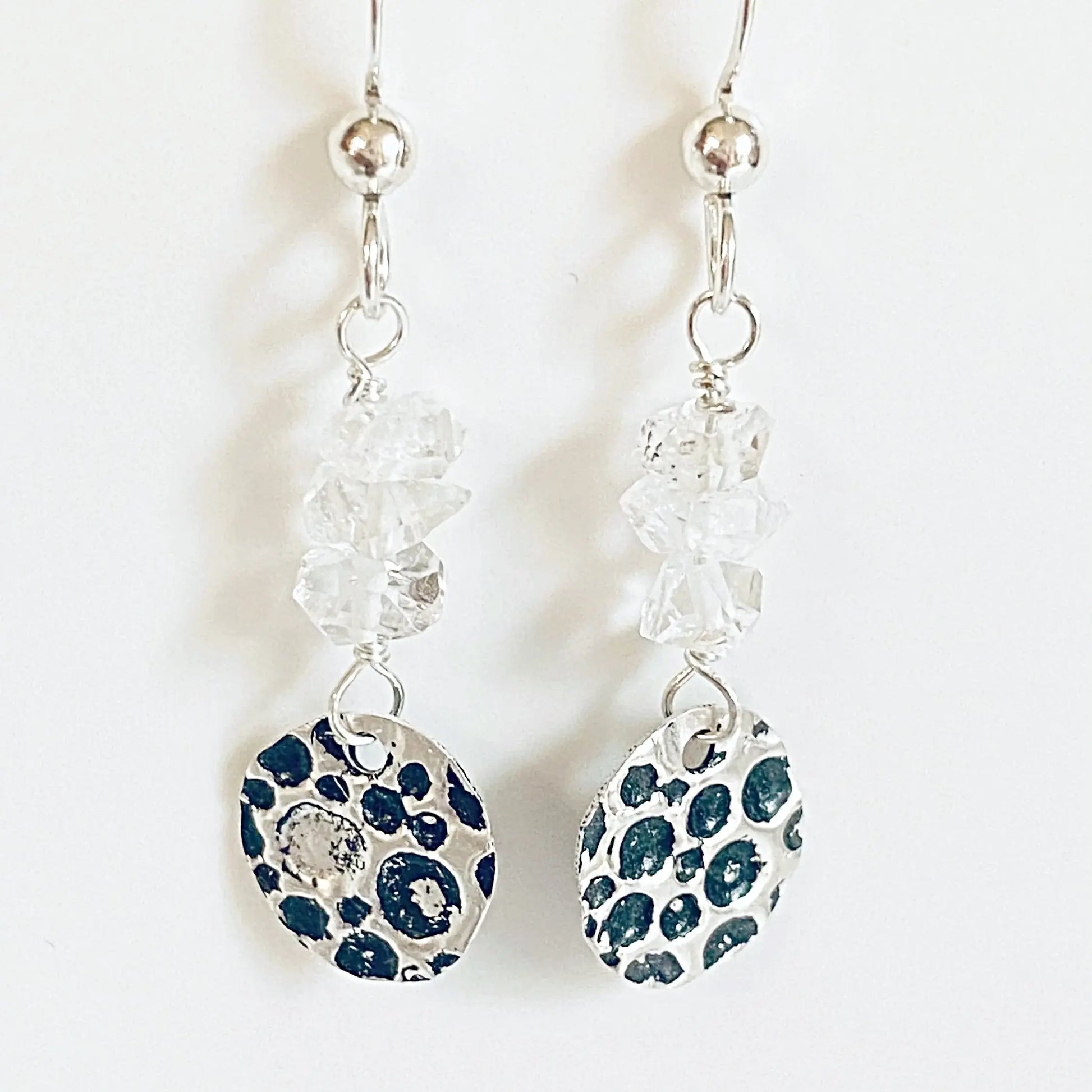 Herkimer Diamond Silver Earrings with dark-accented sterling circle charms and raw crystal beads. Unique artisan earrings for elegant style.