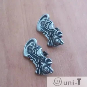 Human Ear Anatomy Earrings laid flat to show detailed ear canal and cochlea design. Unique ear jewelry for medical and science communities.