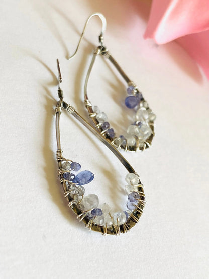 Sterling silver teardrop earrings wire wrapped with Iolite and Moonstone. Elegant gemstone crusted design for all occasions.