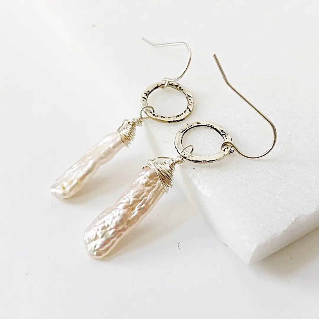 Keshi Pearl Earrings with hand-wrapped freshwater pearls and textured sterling silver circle links. Elegant 2-inch dangle design for versatile wear.