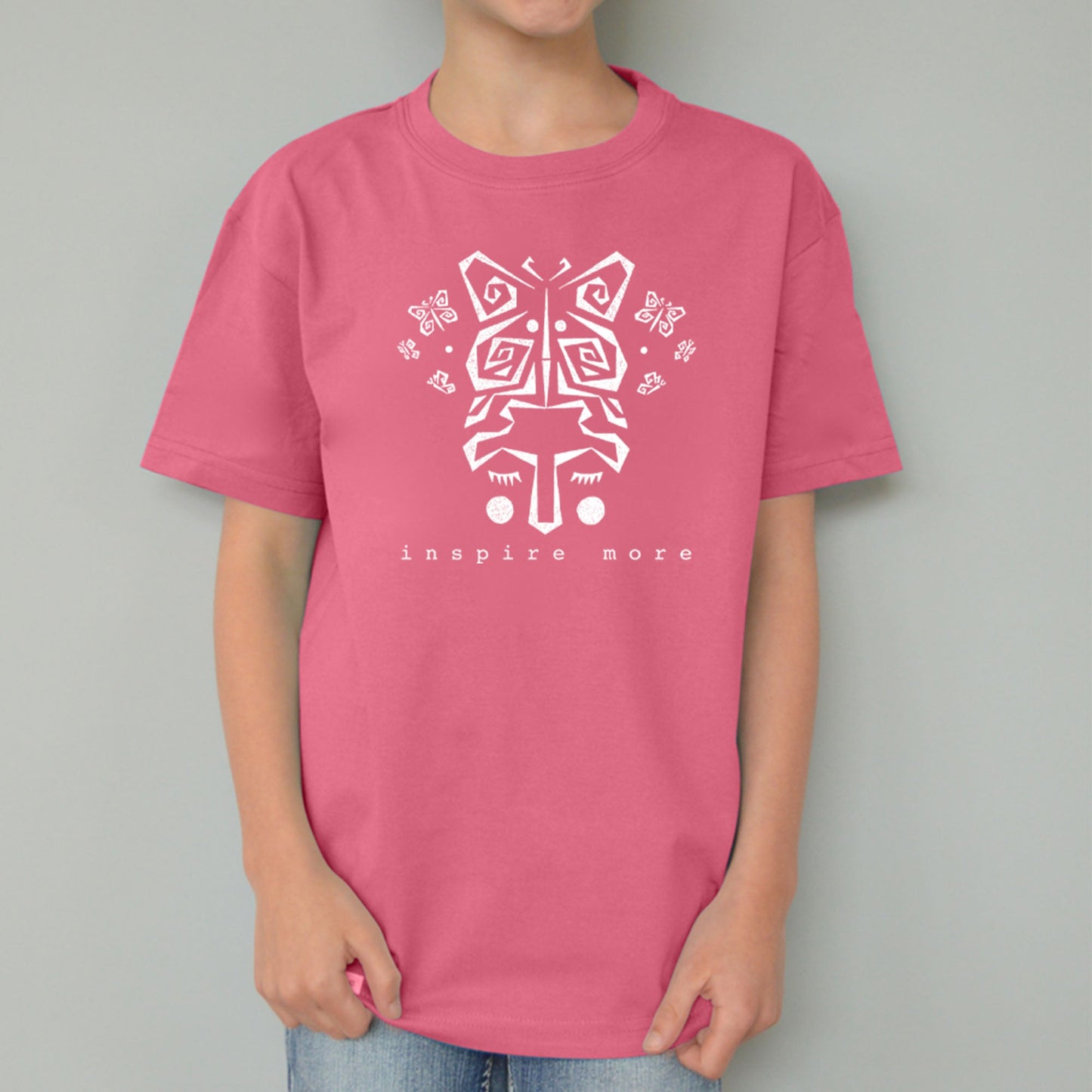 Pink kids' butterfly t-shirt in organic cotton with white 'Inspire More' print. Sustainable Uni-T graphic tee promoting positivity and nature.