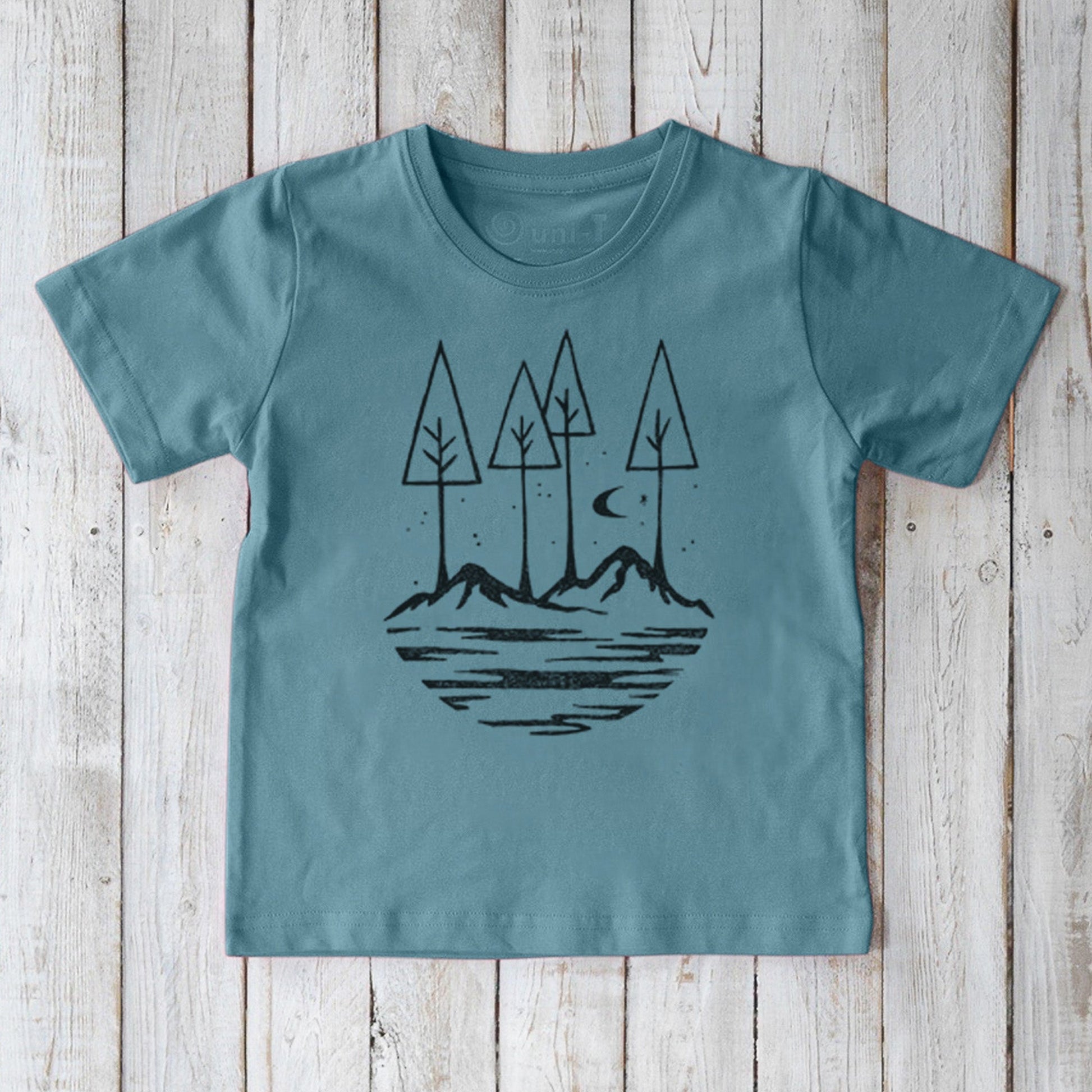 Soft blue Kids' Nature T-Shirt in 100% organic cotton, featuring a peaceful mountain and tree design, perfect for eco-conscious families.