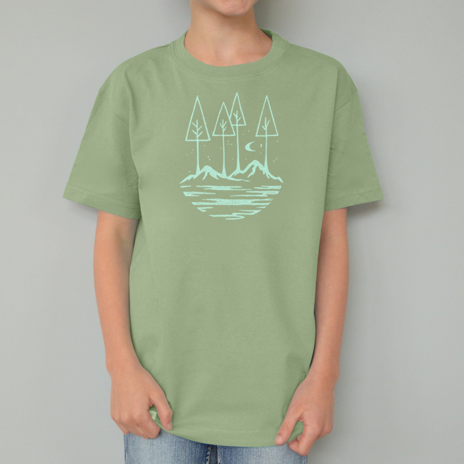 Sage green Kids' Organic Cotton T-Shirt with nature-inspired mountain and tree graphic, a thoughtful and eco-friendly gift for children.