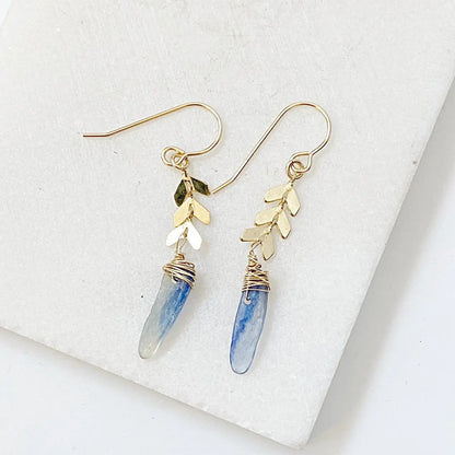 Kyanite Chevron Earrings featuring natural blue kyanite drops, gold-plated chevron charms, and delicate gold ear hooks for a refined look.