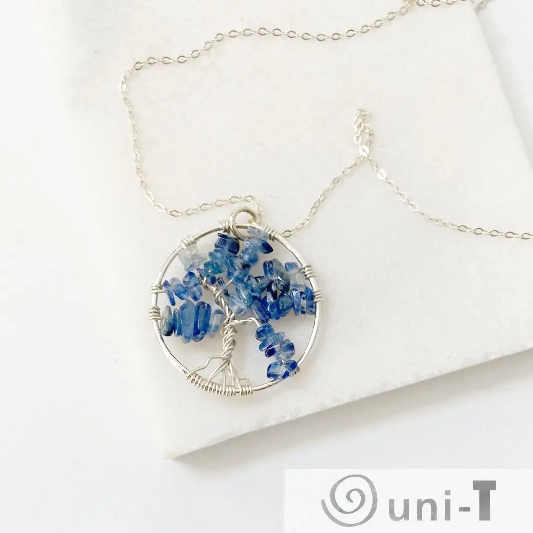 Kyanite Necklace - Tree of Life Sterling Silver featuring a circular wire-wrapped pendant with blue kyanite chips on a delicate silver chain.