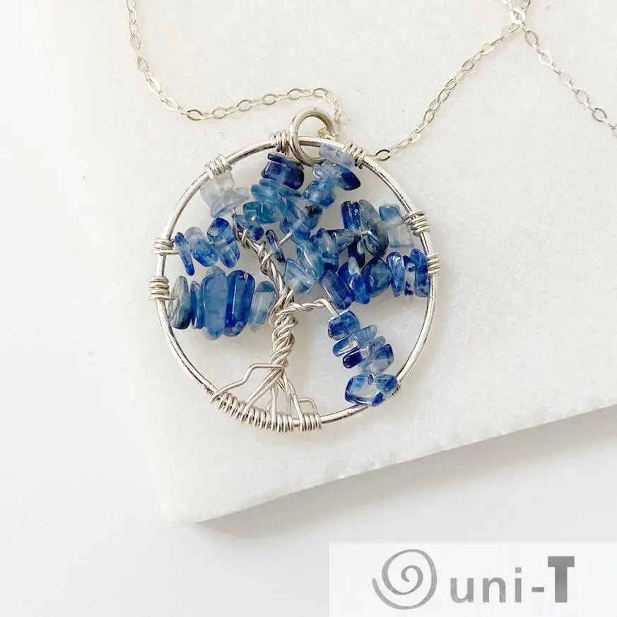 Close-up of Kyanite Tree of Life Necklace with sterling silver wire forming a tree shape adorned with polished blue kyanite chips.