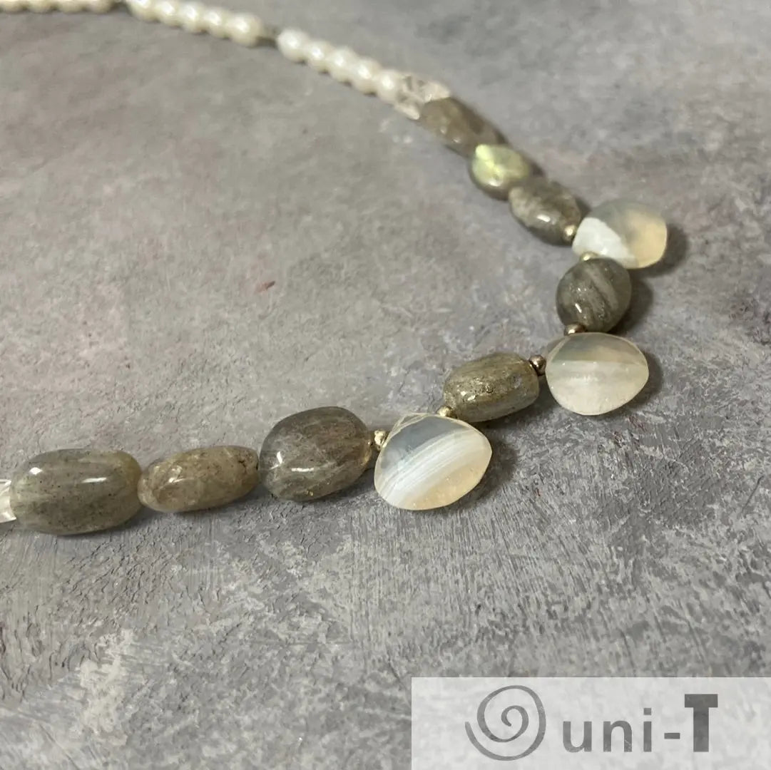 Labradorite pearl necklace with sterling silver clasp featuring quartz beads and dendritic opal accents on a textured grey background.