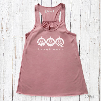 Women's flowy tank top in mauve with 'Laugh More' print featuring three smiling cartoon characters. Eco-friendly racerback design for casual wear.