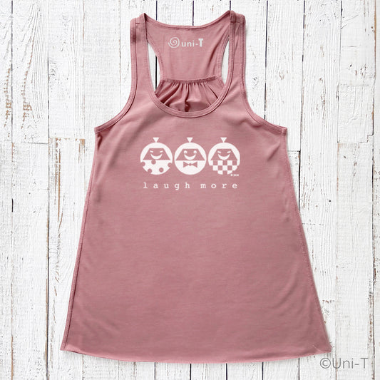 Women's flowy tank top in mauve with 'Laugh More' print featuring three smiling cartoon characters. Eco-friendly racerback design for casual wear.