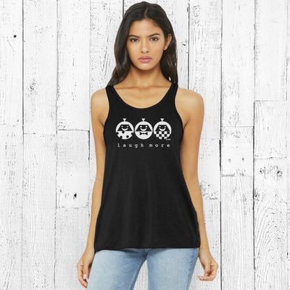 Black women's flowy tank top with 'Laugh More' graphic in white. Soft poly-viscose blend ideal for positive, everyday fashion.