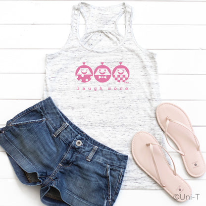 White speckled women's tank top with pink 'Laugh More' design, styled with denim shorts and sandals. Perfect for a fun, casual summer look.