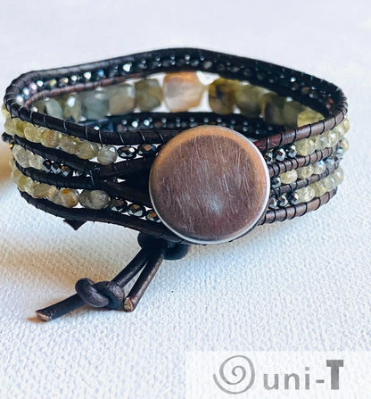 Back view of leather gemstone bracelet with brass button closure, featuring pearl, labradorite, and hematite in a multi-strand wrap style.