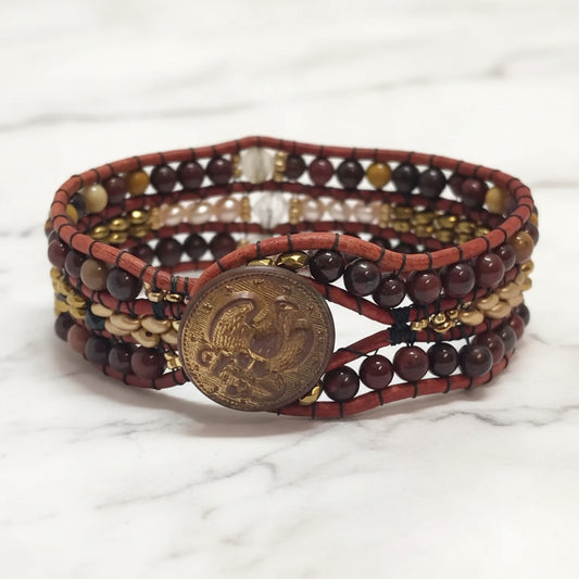 Front view of quartz and leather gemstone cuff bracelet featuring hematite, citrine, and mookaite beads with brass button.