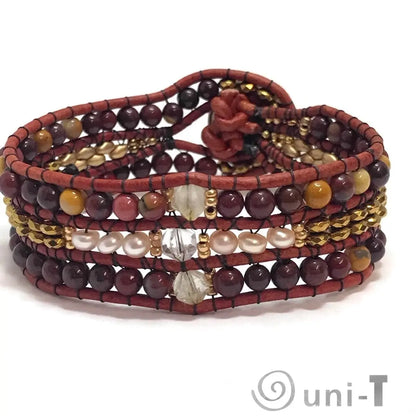 Back view of multi gemstone cuff bracelet with pearl, quartz, and leather detailing, secured by a floral loop closure.