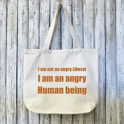Liberal organic canvas tote bag with brown text reading 'I am not an angry Liberal, I am an angry Human being' on eco-friendly fabric.
