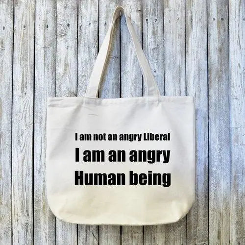 Eco-friendly liberal canvas tote bag with bold black activist quote, perfect for political gifting and social justice supporters.