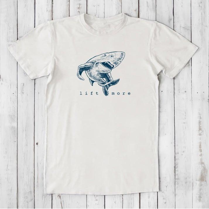 White men's graphic t-shirt with shark and 'Lift More' text, made from eco-friendly bamboo and organic cotton blend.