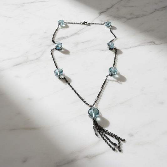 20-inch long crystal chain necklace featuring iridescent beads and a dark brass chain with tassel, ideal for stylish layering jewelry.