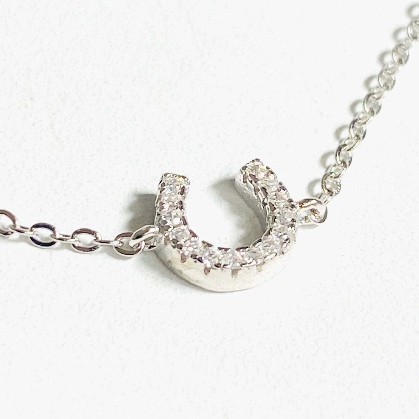 Luck Bracelet - Sterling Silver Charm features a pave rhinestone horseshoe on a delicate silver chain. Adjustable 7"-7.75" with spring ring clasp.