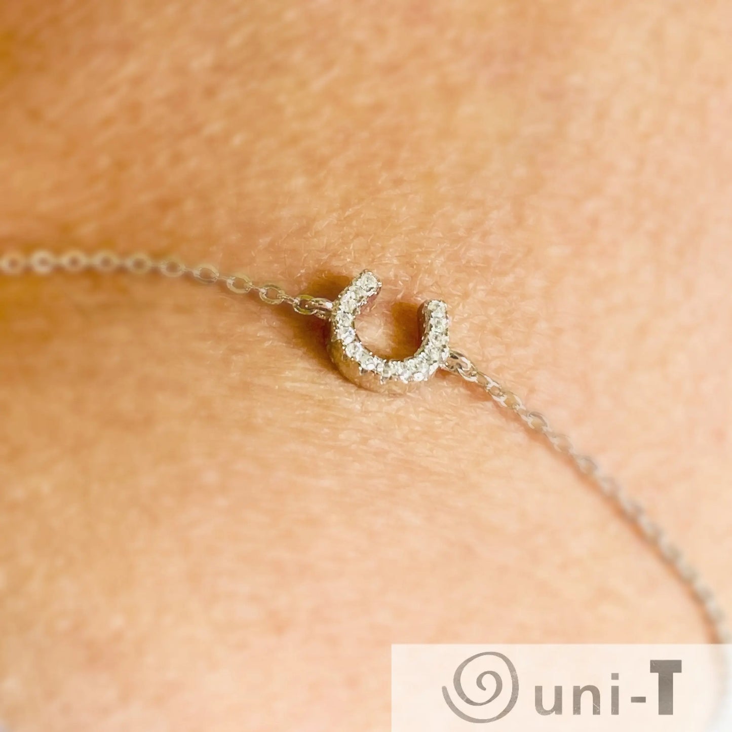 Sterling silver Luck Bracelet with rhinestone horseshoe charm shown on wrist. Elegant and adjustable for a secure, stylish fit.