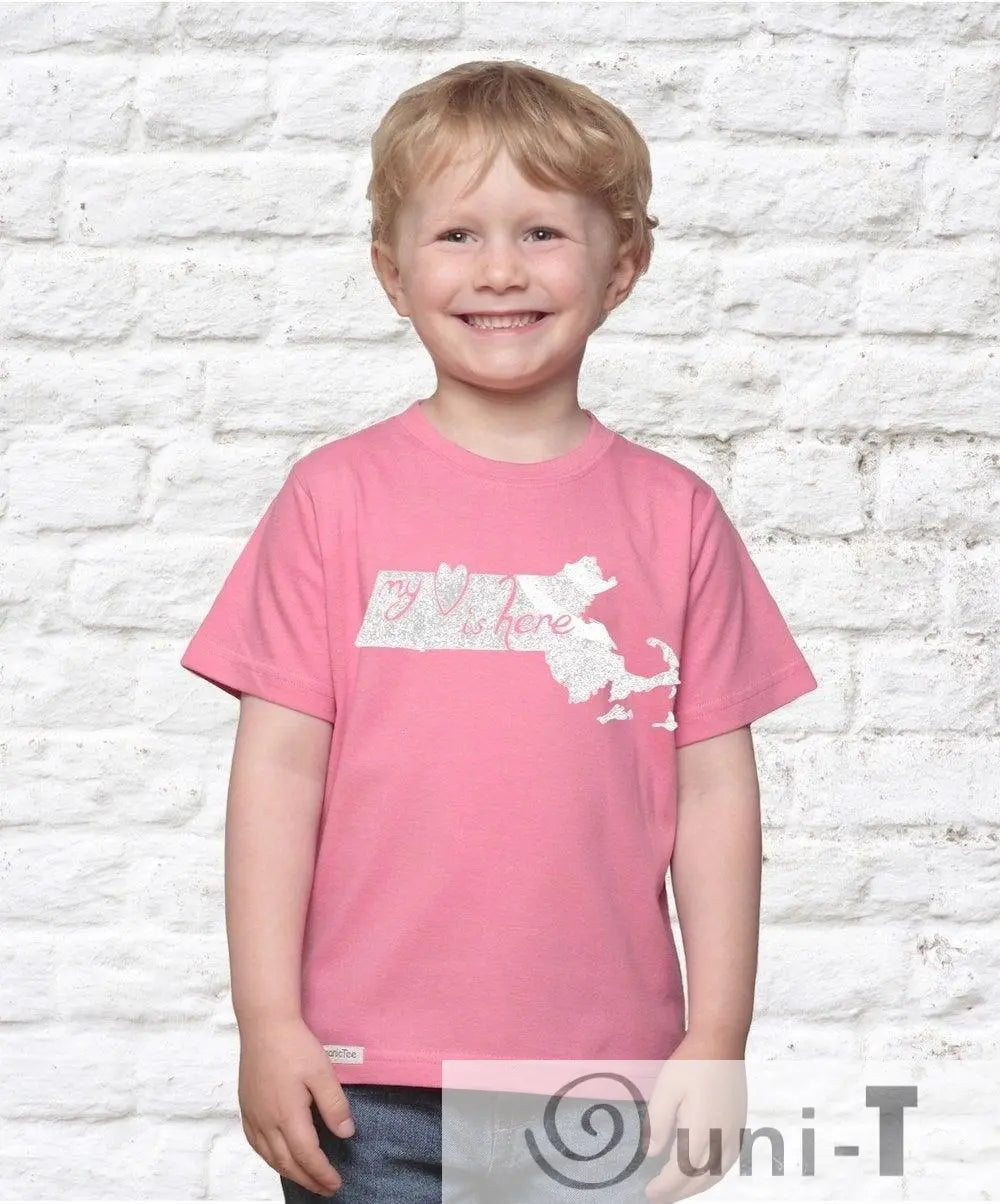 Smiling child wearing pink Massachusetts organic cotton T-shirt with 'My Heart Is Here' print. Sustainable kids' graphic tee by Uni-T.